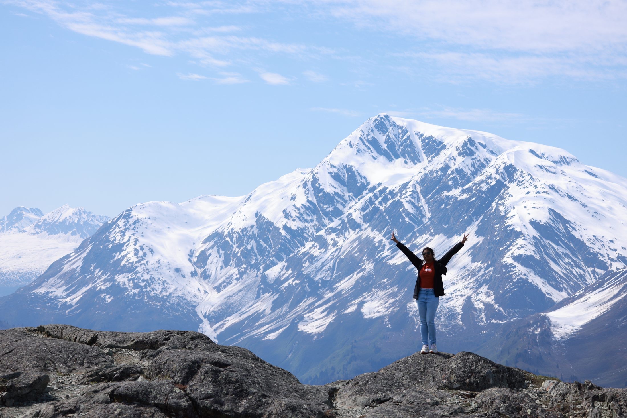 JP standing before a snow-covered Alaska mountain range