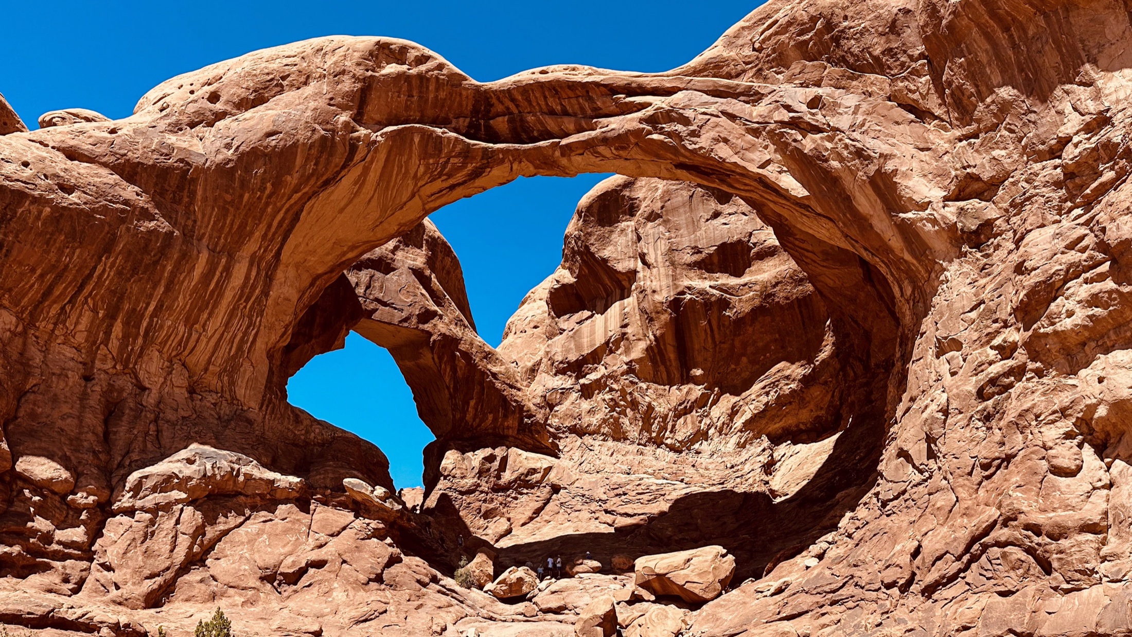Overlapping sandstone arches viewed from below