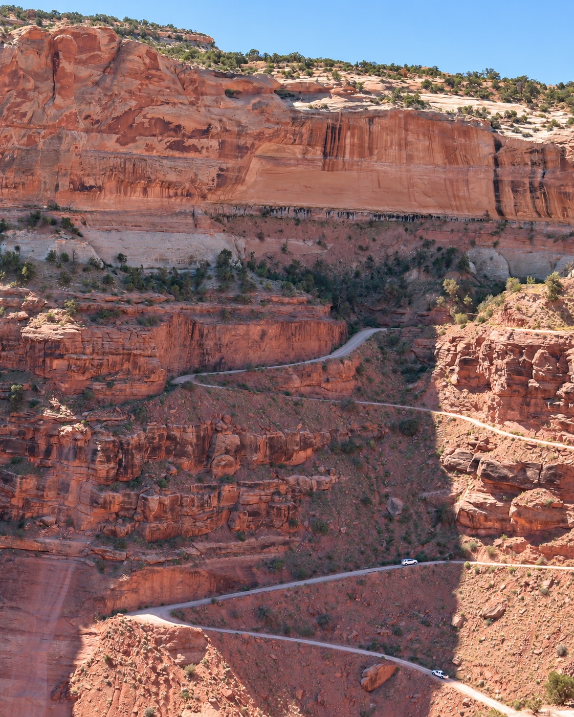 A winding backcountry road descending through Canyonlands