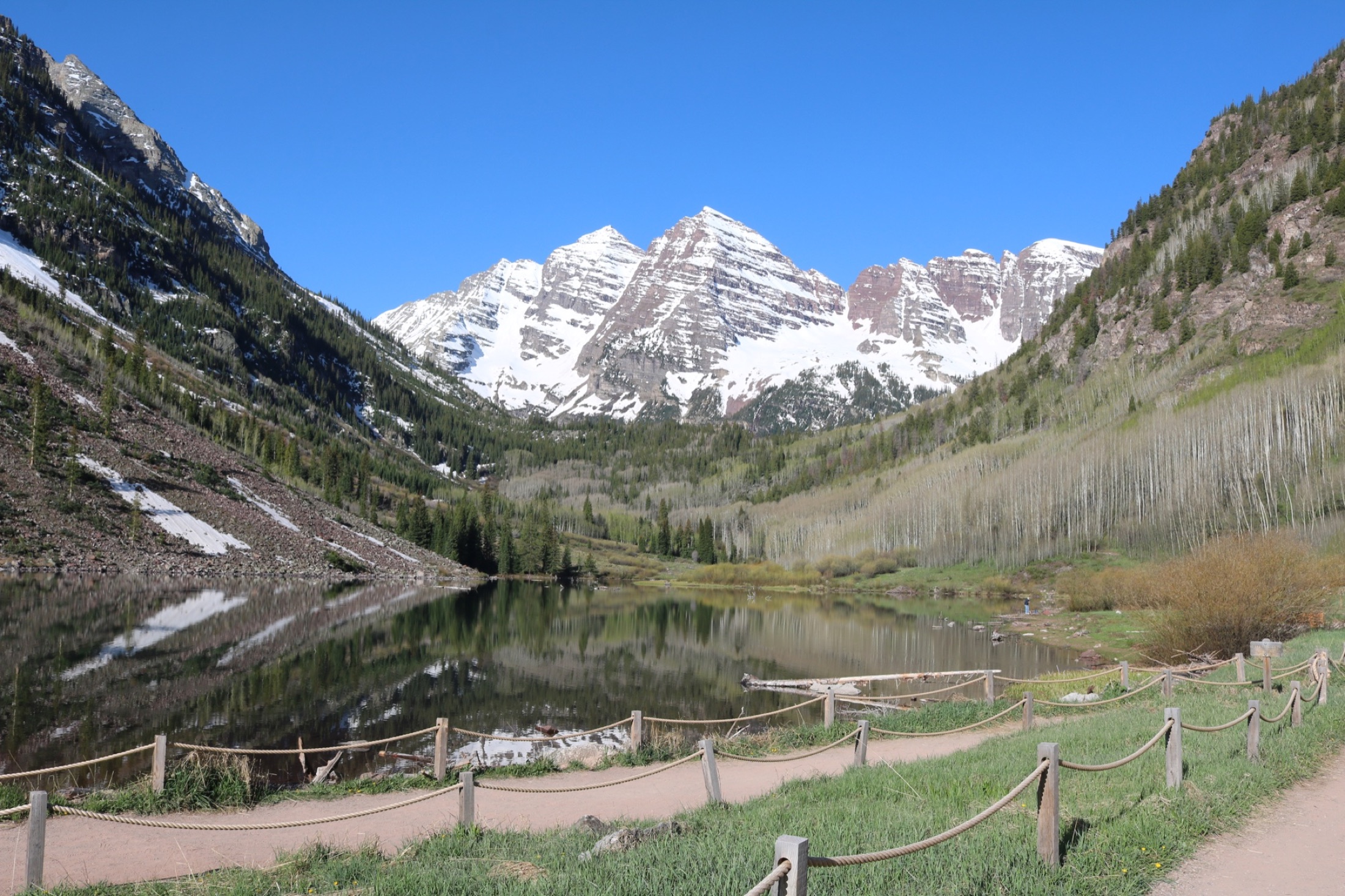 The Maroon Bells reflected in a calm alpine lake near Aspen