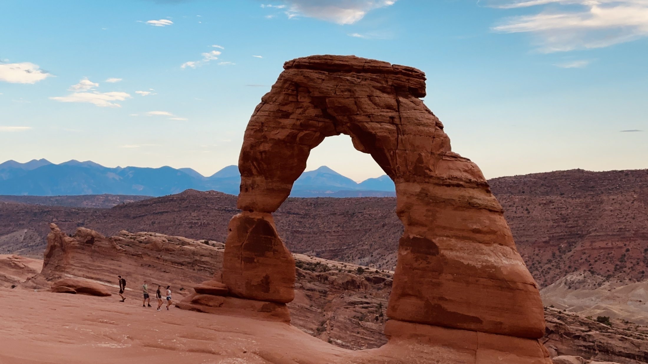 Delicate Arch framed by desert and evening sky